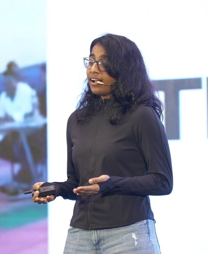Vedhashree Vinoth speaking on stage